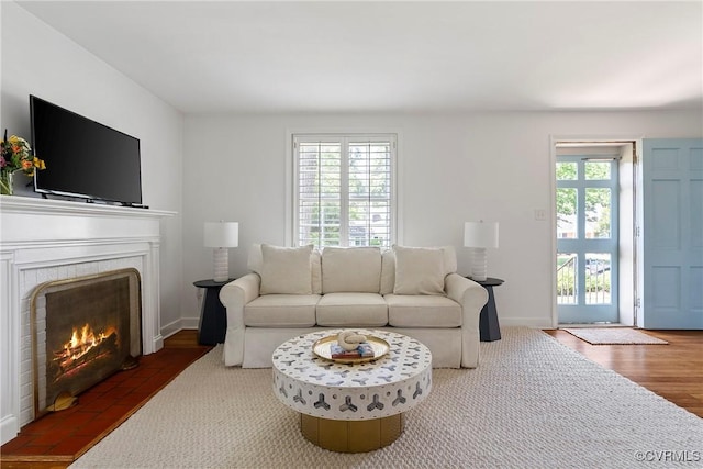 6502 W Franklin St, Henrico, VA 23226 - living area featuring a warm lit fireplace and wood finished floors