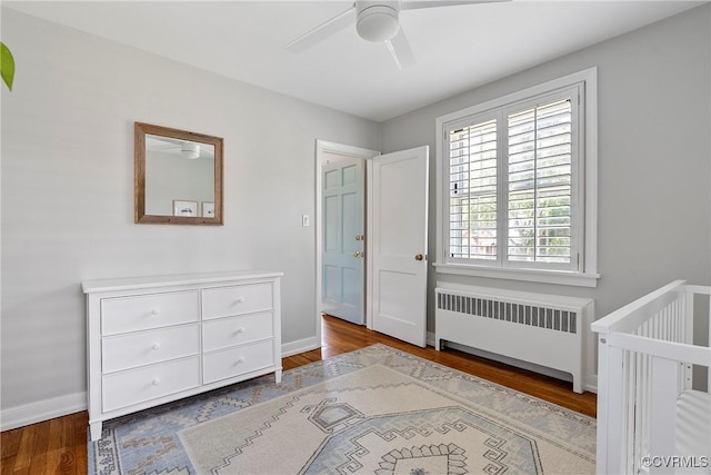 6502 W Franklin St, Henrico, VA 23226 - bedroom featuring radiator heating unit, wood finished floors, and a ceiling fan