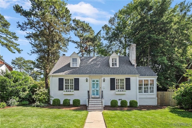 6502 W Franklin St, Henrico, VA 23226 - cape cod home featuring a chimney, roof with shingles, entry steps, and brick siding