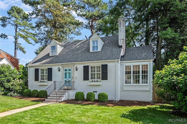 6502 W Franklin St, Henrico, VA 23226 - cape cod-style house featuring a front yard, a chimney, roof with shingles, and brick siding