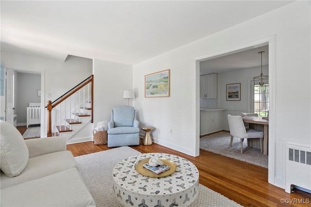 6502 W Franklin St, Henrico, VA 23226 - living area with radiator heating unit, wood finished floors, and stairway