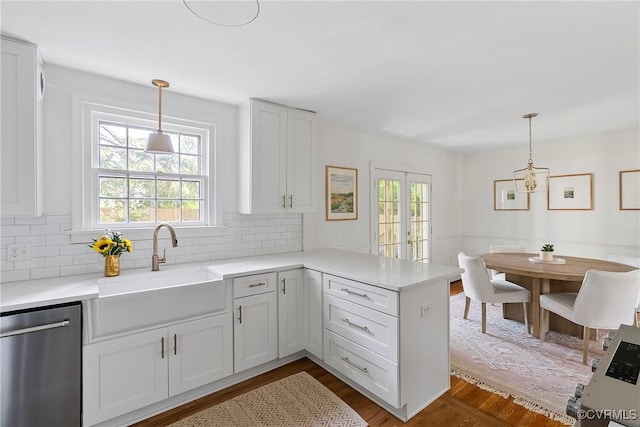 6502 W Franklin St, Henrico, VA 23226 - kitchen featuring stainless steel dishwasher, a peninsula, tasteful backsplash, and light countertops