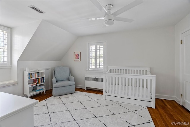 6502 W Franklin St, Henrico, VA 23226 - bedroom with radiator, wood finished floors, a nursery area, ceiling fan, and lofted ceiling
