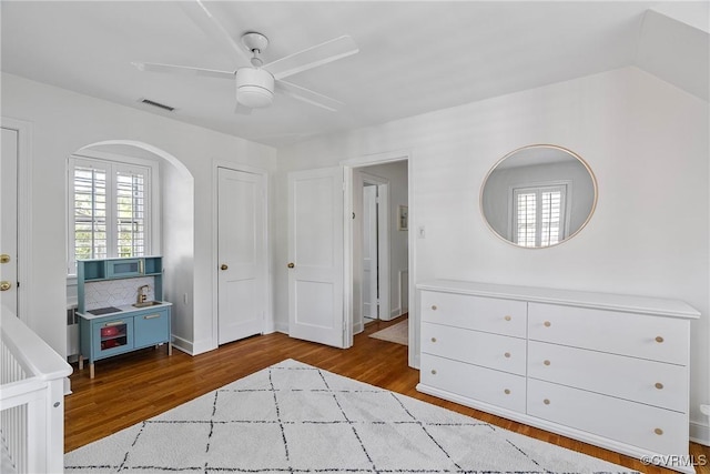 6502 W Franklin St, Henrico, VA 23226 - unfurnished bedroom with wood finished floors, arched walkways, and ceiling fan