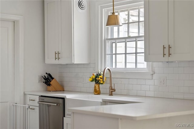 6502 W Franklin St, Henrico, VA 23226 - kitchen with dishwasher, white cabinetry, light countertops, and backsplash