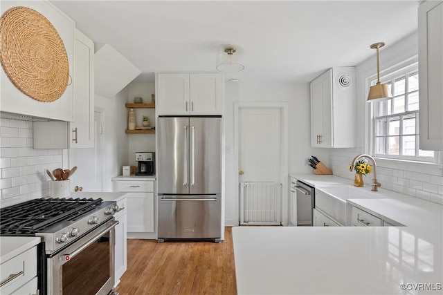 6502 W Franklin St, Henrico, VA 23226 - kitchen with appliances with stainless steel finishes, tasteful backsplash, and white cabinets