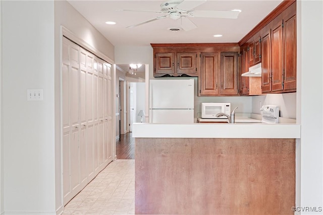 13542 Heathbrook Ter, Midlothian, VA 23112 - kitchen with white appliances, under cabinet range hood, a ceiling fan, a peninsula, and light countertops