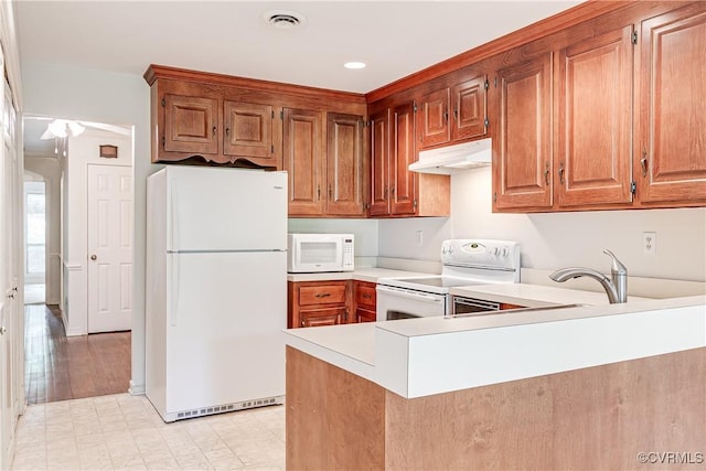 13542 Heathbrook Ter, Midlothian, VA 23112 - kitchen featuring white appliances, under cabinet range hood, light countertops, a peninsula, and brown cabinets