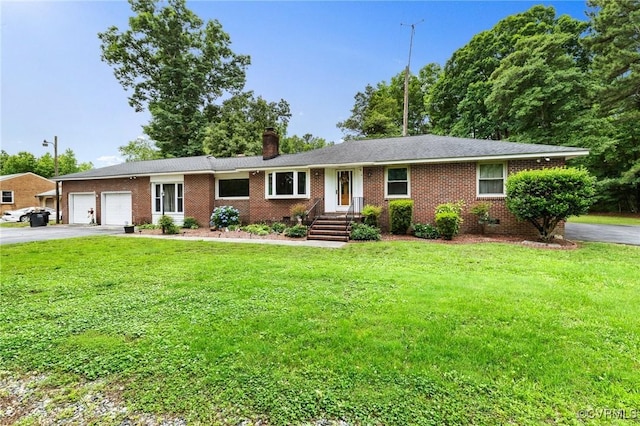 12418 Gravelbrook Rd, South Prince George, VA 23805 - single story home featuring driveway, an attached garage, a chimney, a front lawn, and brick siding