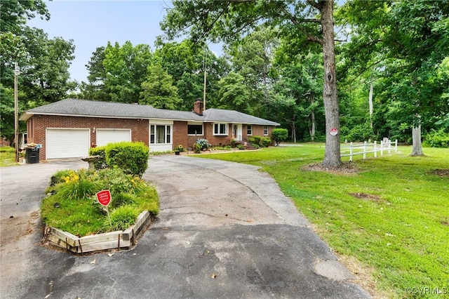 12418 Gravelbrook Rd, South Prince George, VA 23805 - ranch-style house with asphalt driveway, an attached garage, brick siding, a chimney, and view of scattered trees