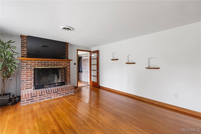 12418 Gravelbrook Rd, South Prince George, VA 23805 - unfurnished living room with wood finished floors and a fireplace