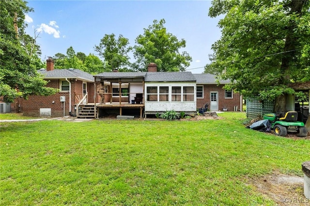 12418 Gravelbrook Rd, South Prince George, VA 23805 - rear view of house with a sunroom, a lawn, a wooden deck, a chimney, and brick siding