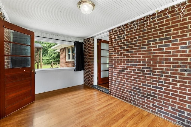 12418 Gravelbrook Rd, South Prince George, VA 23805 - empty room featuring brick wall and wood finished floors