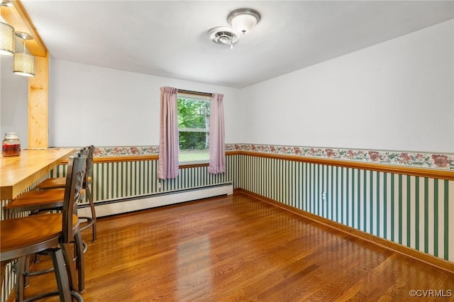 12418 Gravelbrook Rd, South Prince George, VA 23805 - spare room with a baseboard radiator, wood finished floors, wallpapered walls, and a wainscoted wall