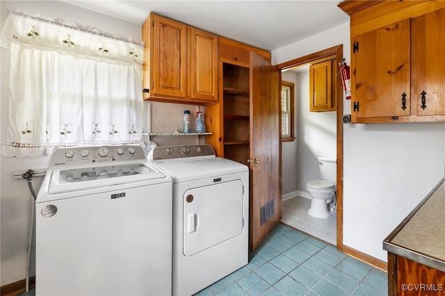 12418 Gravelbrook Rd, South Prince George, VA 23805 - laundry room featuring washing machine and clothes dryer, plenty of natural light, and light tile patterned floors