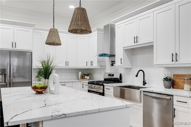 11 W 29th St, Richmond, VA 23225 - kitchen featuring appliances with stainless steel finishes, wall chimney range hood, a center island, hanging light fixtures, and white cabinets
