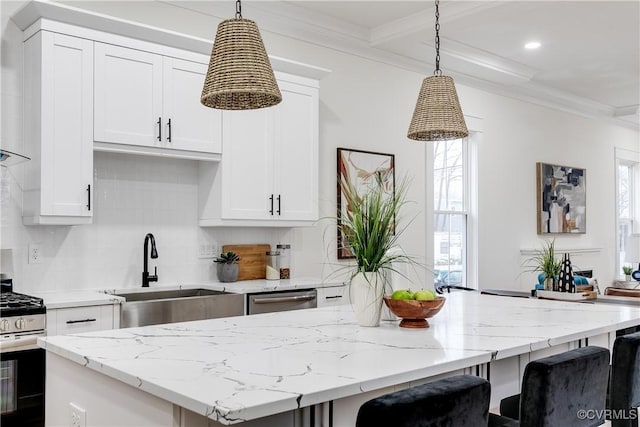 11 W 29th St, Richmond, VA 23225 - kitchen with appliances with stainless steel finishes, a kitchen island, crown molding, backsplash, and white cabinets