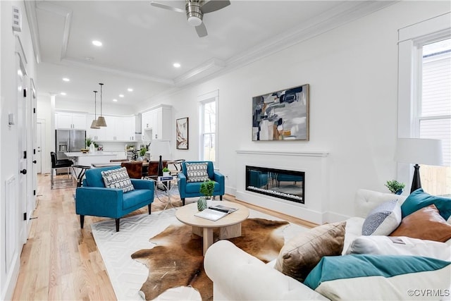 11 W 29th St, Richmond, VA 23225 - living room featuring light wood finished floors, ornamental molding, ceiling fan, recessed lighting, and a glass covered fireplace