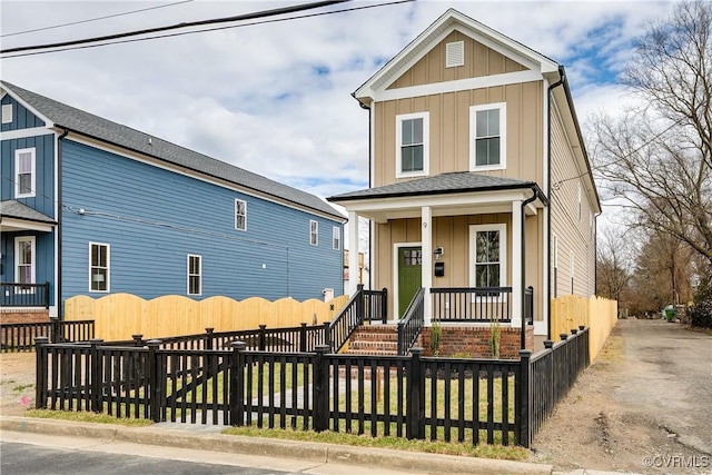 11 W 29th St, Richmond, VA 23225 - view of front facade featuring a porch, board and batten siding, and a fenced front yard