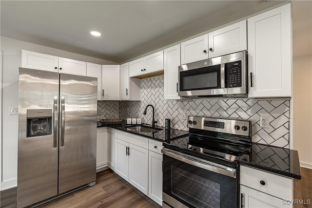 833 Wilcox St, Petersburg, VA 23803 - kitchen with stainless steel appliances, dark wood-style flooring, white cabinets, dark stone countertops, and recessed lighting