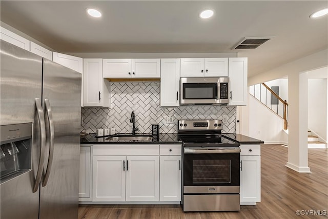 833 Wilcox St, Petersburg, VA 23803 - kitchen featuring stainless steel appliances, white cabinetry, backsplash, and recessed lighting