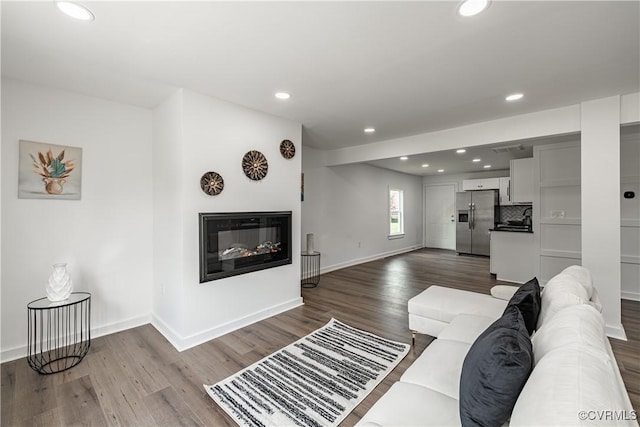 833 Wilcox St, Petersburg, VA 23803 - living room with a glass covered fireplace, dark wood-style flooring, and recessed lighting