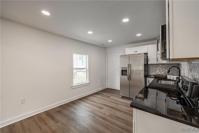 833 Wilcox St, Petersburg, VA 23803 - kitchen featuring stainless steel fridge, tasteful backsplash, recessed lighting, wood finished floors, and white cabinetry