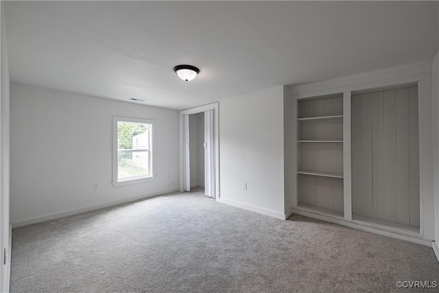 833 Wilcox St, Petersburg, VA 23803 - unfurnished bedroom featuring carpet floors and two closets