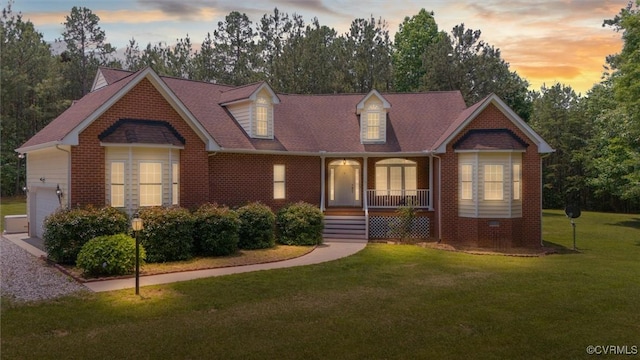 13531 Butlers Rd, Amelia Courthouse, VA 23002 - cape cod home featuring a porch, brick siding, a lawn, an attached garage, and view of scattered trees