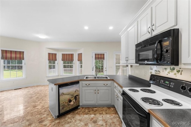 13531 Butlers Rd, Amelia Courthouse, VA 23002 - kitchen featuring range with electric stovetop, black microwave, dishwasher, a peninsula, and dark countertops