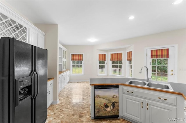 13531 Butlers Rd, Amelia Courthouse, VA 23002 - kitchen featuring black fridge, dishwasher, white cabinetry, plenty of natural light, and recessed lighting