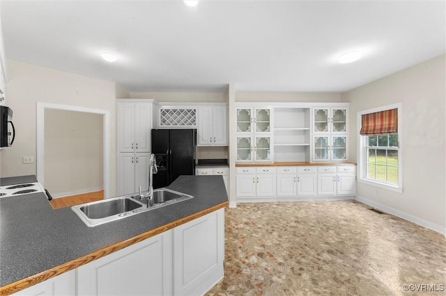 13531 Butlers Rd, Amelia Courthouse, VA 23002 - kitchen with black appliances, dark countertops, white cabinets, glass insert cabinets, and open shelves