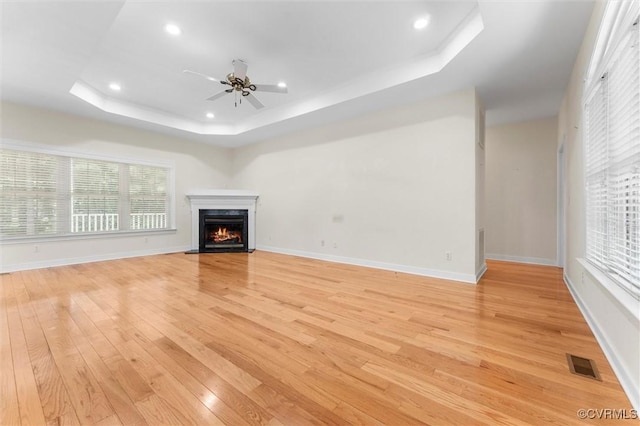 13531 Butlers Rd, Amelia Courthouse, VA 23002 - unfurnished living room featuring a tray ceiling, a ceiling fan, light wood-style flooring, recessed lighting, and a premium fireplace