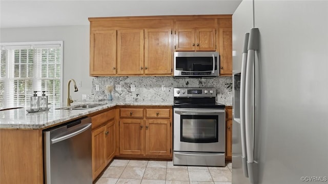 500 Village Gate Dr, Midlothian, VA 23114 - kitchen with appliances with stainless steel finishes, a peninsula, backsplash, light stone countertops, and light tile patterned floors