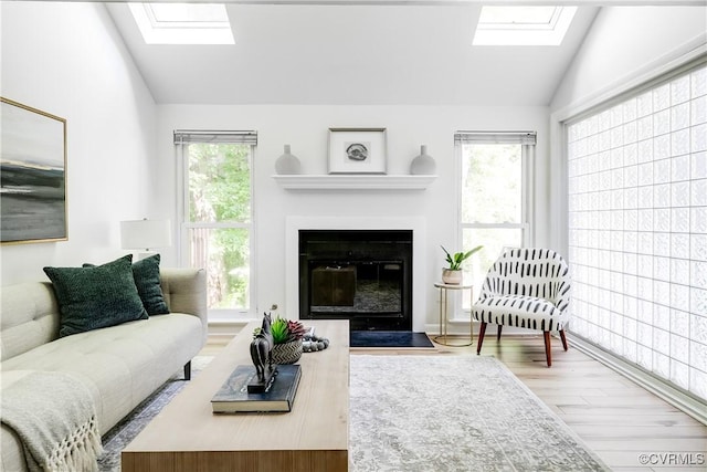 4814 Long Shadow Dr, Chesterfield, VA 23112 - living room featuring a skylight, lofted ceiling, wood finished floors, and a fireplace with flush hearth