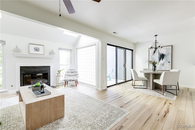 4814 Long Shadow Dr, Chesterfield, VA 23112 - living area with plenty of natural light, light wood-style flooring, a glass covered fireplace, a ceiling fan, and vaulted ceiling