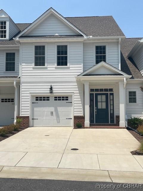 117 Meeting Pl, Williamsburg, VA 23185 - view of front of home with a garage, brick siding, concrete driveway, and roof with shingles