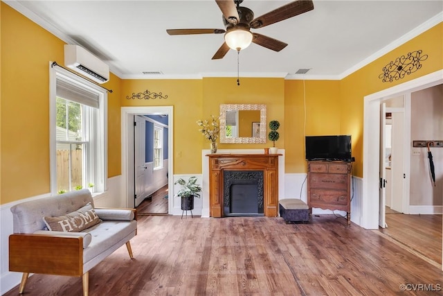 429 4th St, West Point, VA 23181 - living room featuring a wall mounted air conditioner, wood finished floors, a fireplace, a ceiling fan, and crown molding