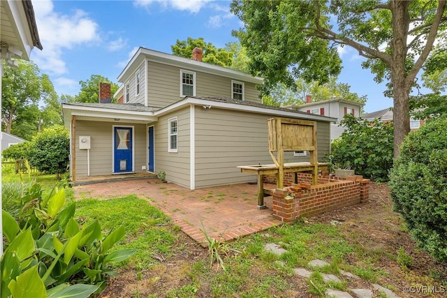 429 4th St, West Point, VA 23181 - rear view of house featuring a chimney and a patio