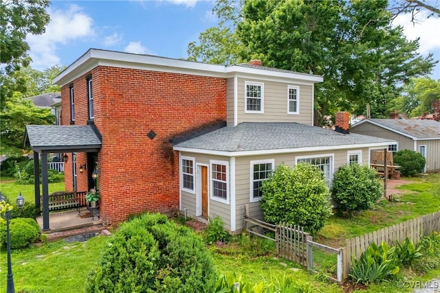 429 4th St, West Point, VA 23181 - rear view of property featuring a shingled roof, a chimney, and brick siding