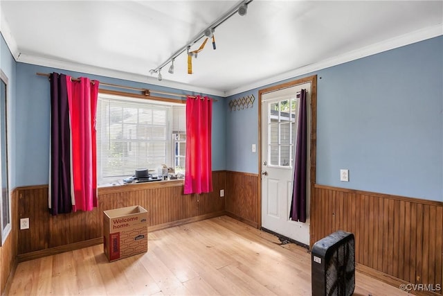 429 4th St, West Point, VA 23181 - spare room with wood walls, a wainscoted wall, wood finished floors, and rail lighting