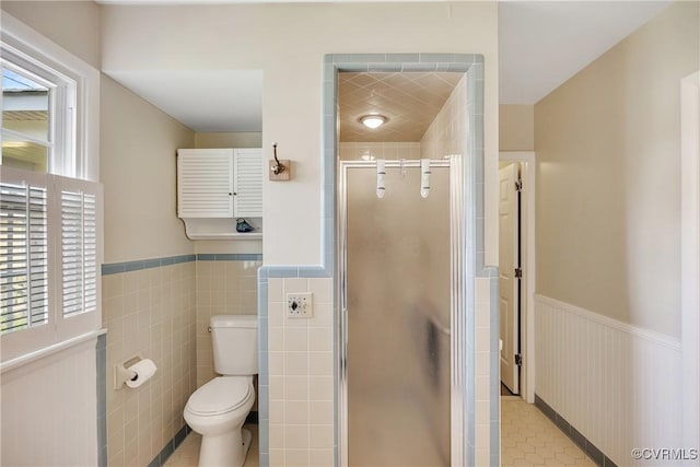 429 4th St, West Point, VA 23181 - bathroom with wainscoting, a stall shower, healthy amount of natural light, and tile patterned floors