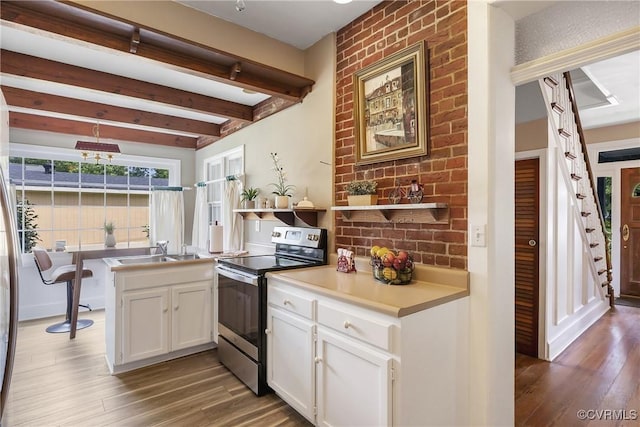 429 4th St, West Point, VA 23181 - kitchen featuring stainless steel electric range, wood finished floors, white cabinetry, beam ceiling, and open shelves