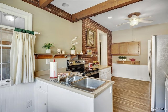 429 4th St, West Point, VA 23181 - kitchen featuring appliances with stainless steel finishes, light wood finished floors, light countertops, a ceiling fan, and beam ceiling