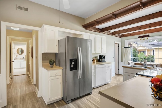 429 4th St, West Point, VA 23181 - kitchen with stainless steel refrigerator with ice dispenser, white dishwasher, white cabinets, light wood-style flooring, and beam ceiling
