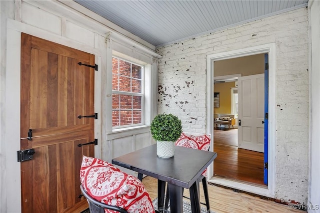 429 4th St, West Point, VA 23181 - dining area with light wood-style flooring and brick wall