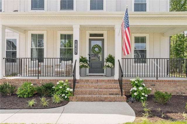 18207 Maple Summit Ct, Moseley, VA 23120 - doorway to property with board and batten siding and covered porch