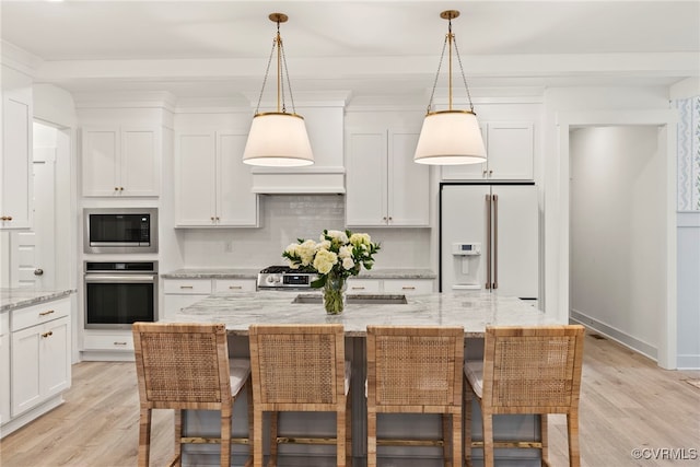 18207 Maple Summit Ct, Moseley, VA 23120 - kitchen featuring appliances with stainless steel finishes, light wood-type flooring, white cabinetry, and backsplash