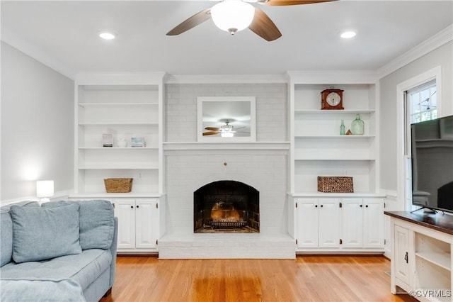 11905 Glen Gary Ct, Henrico, VA 23233 - living room with a ceiling fan, built in features, light wood-style flooring, ornamental molding, and a fireplace