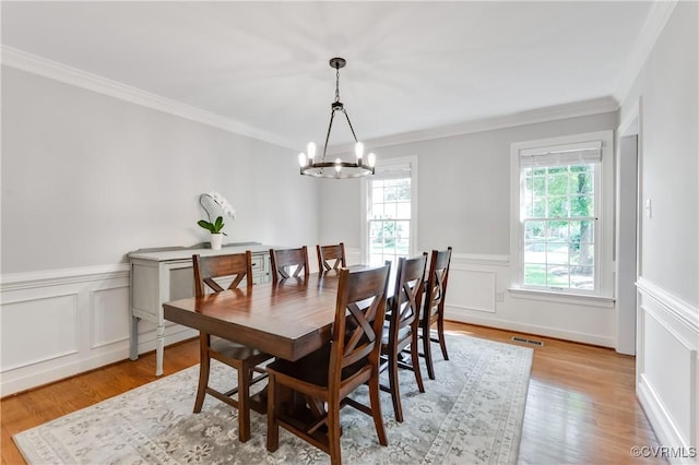 11905 Glen Gary Ct, Henrico, VA 23233 - dining area with a chandelier, ornamental molding, wainscoting, light wood-style flooring, and a decorative wall